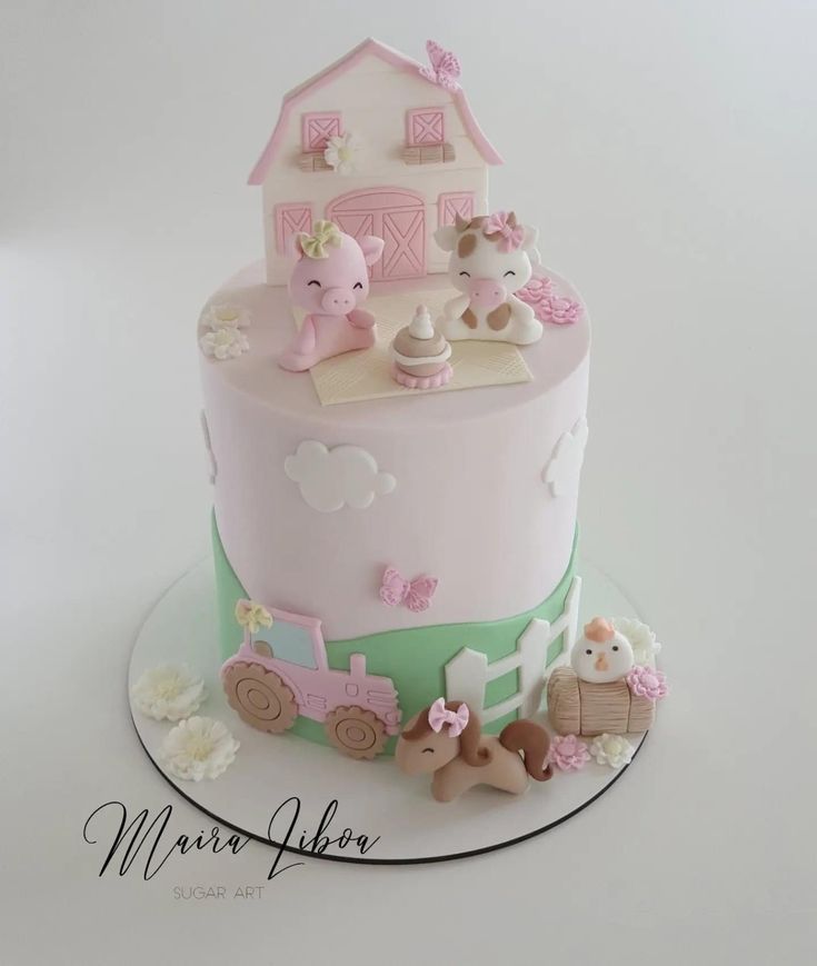 a pink and green cake with farm animals on it