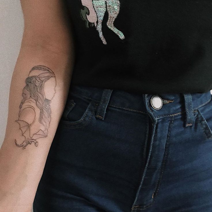 a woman with a tattoo on her arm