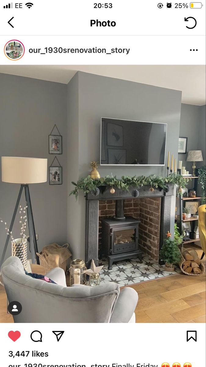 the living room is decorated for christmas with garland on the mantle and tv above it