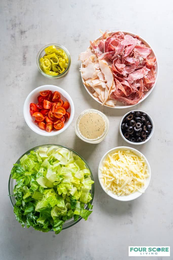 the ingredients for an italian salad laid out in bowls