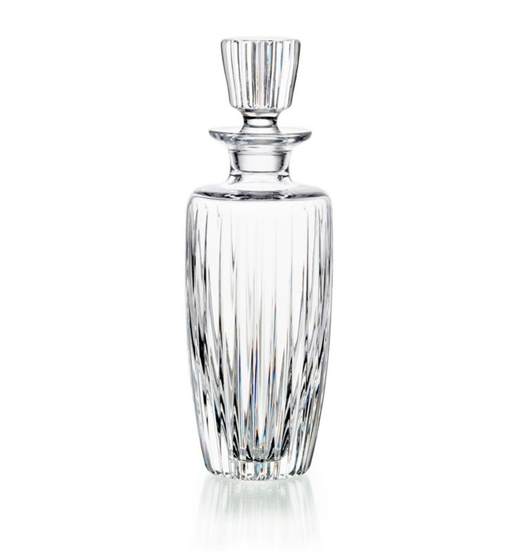 a clear glass bottle with a silver stopper on the top is shown in front of a white background