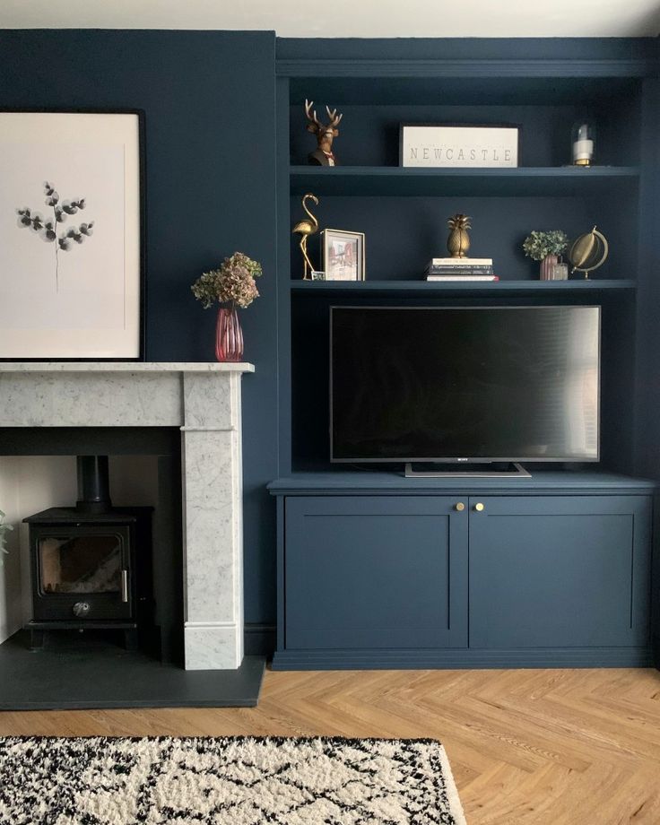 a living room filled with furniture and a flat screen tv on top of a fireplace