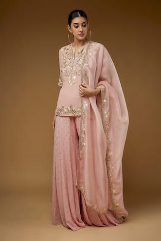 Rose pink short kurta with floral, cutdana, zari hand embroidery. Paired with mukaish embroidered sharara and scallop trimmed dupatta with floral embroidery. - Aza Fashions Pink Palazzo Set With Dori Work, Pink Dori Work Kurta For Reception, Pink Kurta With Dori Work For Reception, Pink Gota Work Salwar Kameez For Reception, Pink Salwar Kameez With Gota Work For Reception, Pink Sharara With Dori Work, Traditional Pink Palazzo Set For Reception, Pink Palazzo Set With Dori Work For Wedding, Pink Palazzo Set With Resham Embroidery For Reception