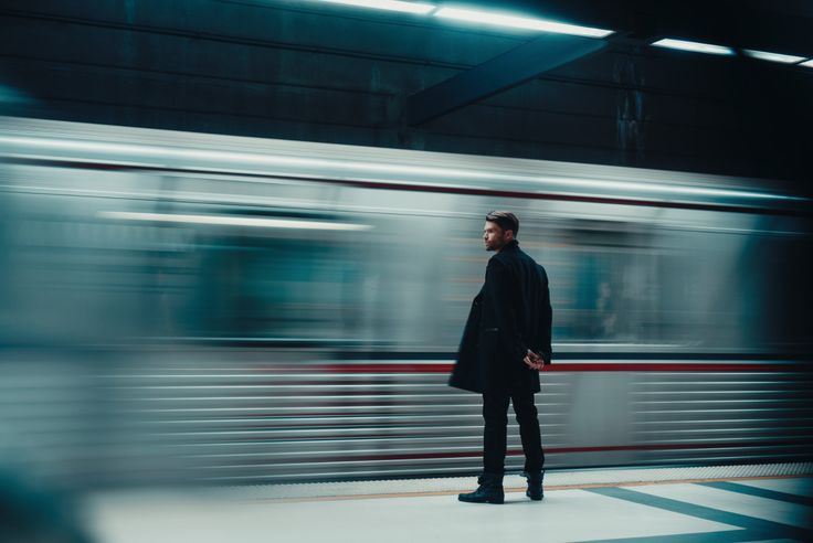 a man standing in front of a train