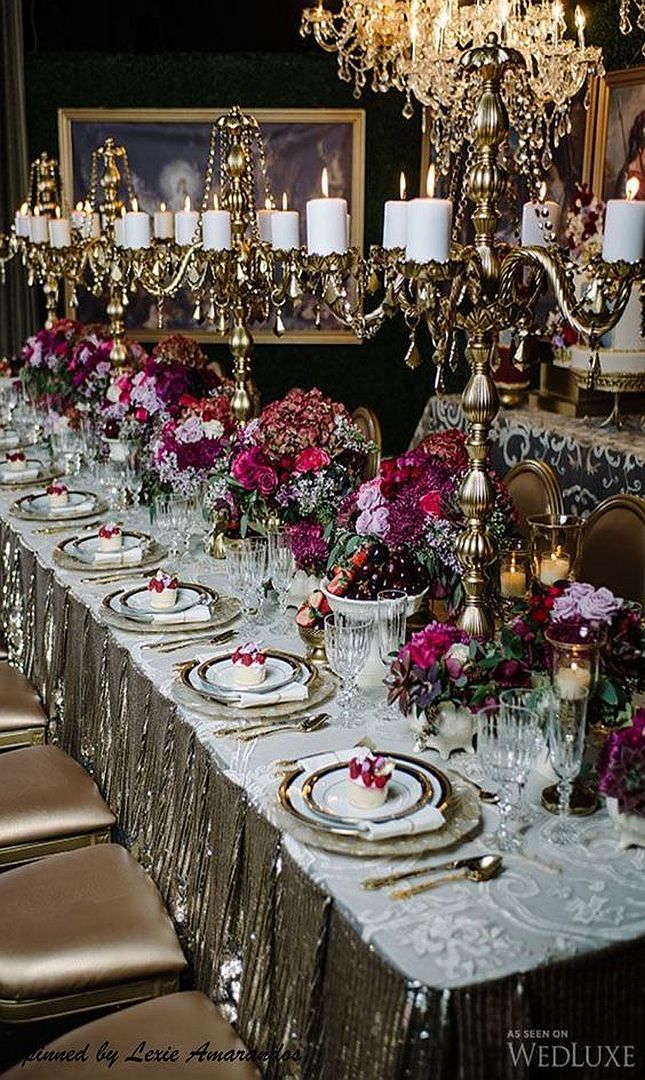 the table is set with flowers and place settings for guests to sit down at it