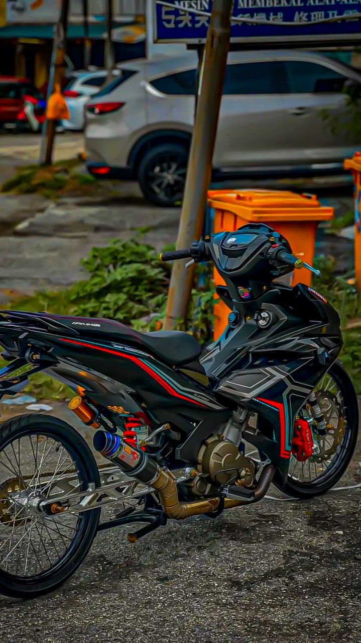 a black motorcycle parked on the side of a road