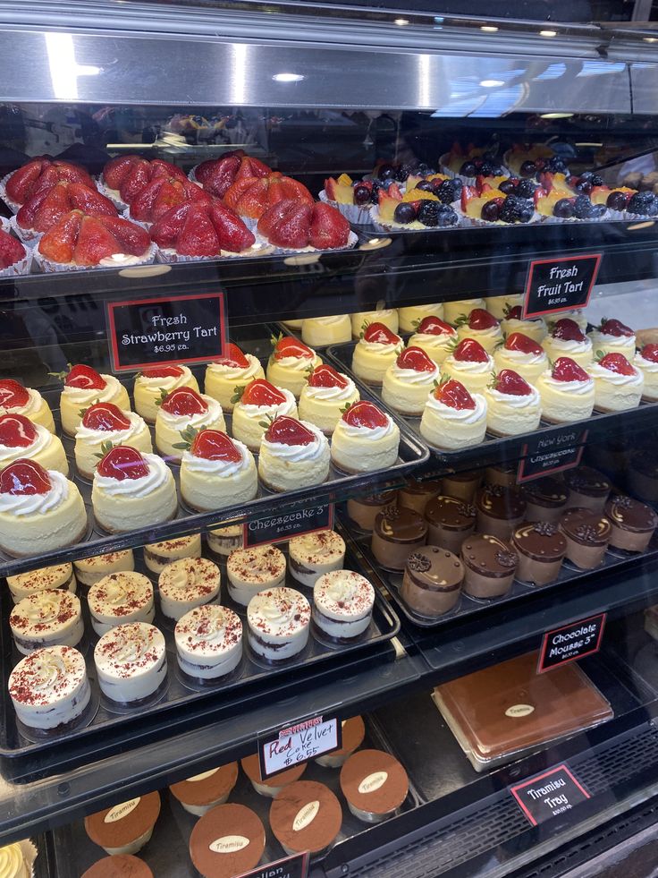 a display case filled with lots of different types of cakes