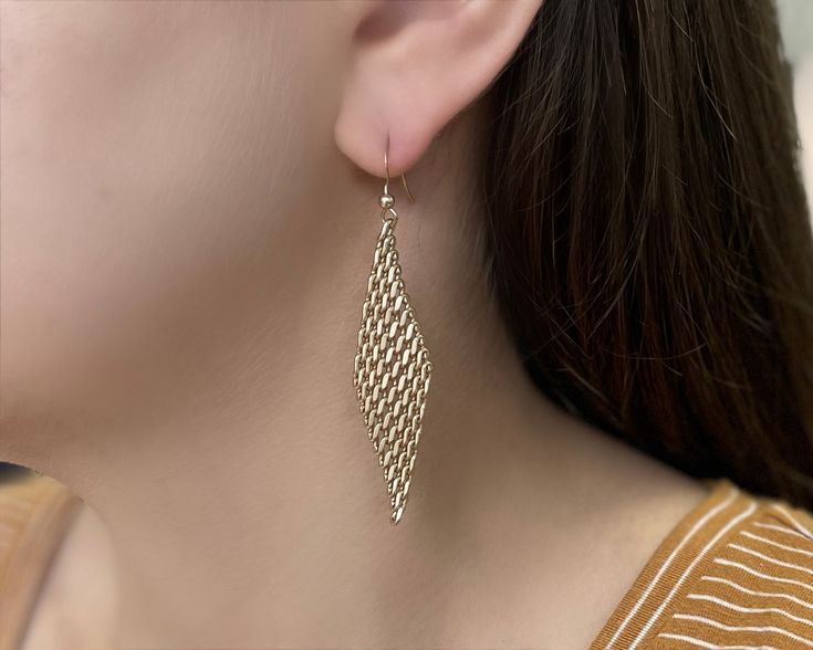 Gold Mesh Earrings in Gold. These 2 3/4" timeless earrings would complete any outfit perfectly. Matte gold plated for a warm golden finish that has a subtle glow. Made from Hypoallergenic Brass Electro-plated Nickel-free Handcrafted in Florida Due to the handcrafted nature of our product, all items will vary slightly Gold Hypoallergenic Metal Earrings, Elegant Cadmium-free Dangle Hoop Earrings, Elegant Gold-plated Cadmium-free Earrings, Elegant Gold Plated Cadmium-free Earrings, Elegant Cadmium-free Teardrop Earrings, Elegant Cadmium-free Yellow Gold Earrings, Gold Hypoallergenic Teardrop Chandelier Earrings, Hypoallergenic Brass Earrings For Formal Occasions, Hypoallergenic Brass Earrings For Formal Events