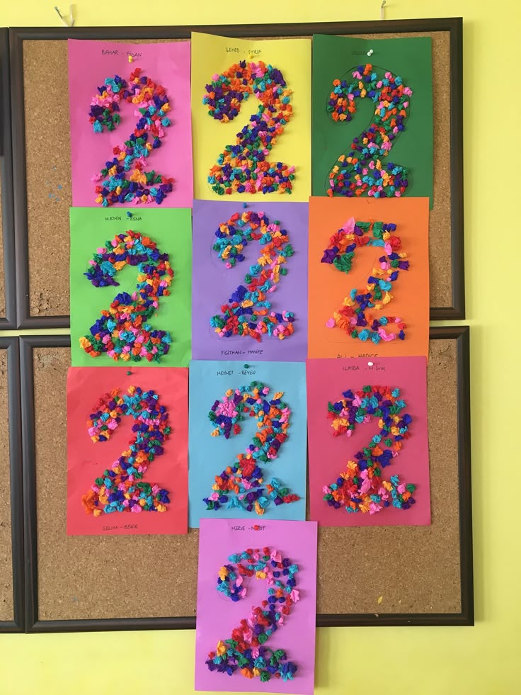 a bulletin board with numbers made out of colored paper and sprinkles on it