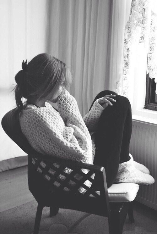 a woman sitting in a chair with her back to the camera and texting that reads,