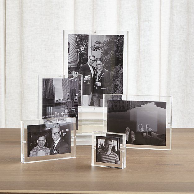 four photos are placed on top of a wooden table