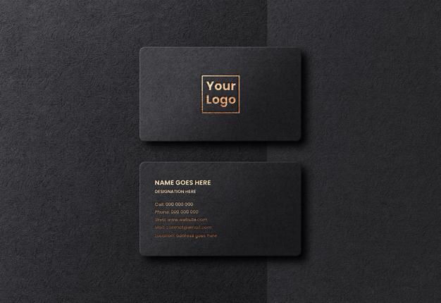 two black business cards with gold foil on the front and back, sitting next to each other