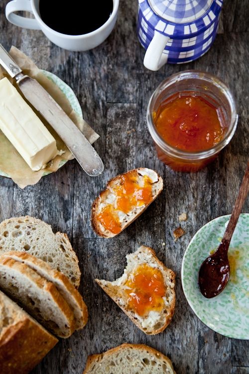 bread, jam and butter on a wooden table