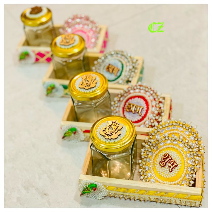 four small trays filled with different types of cookies and jam on top of a table