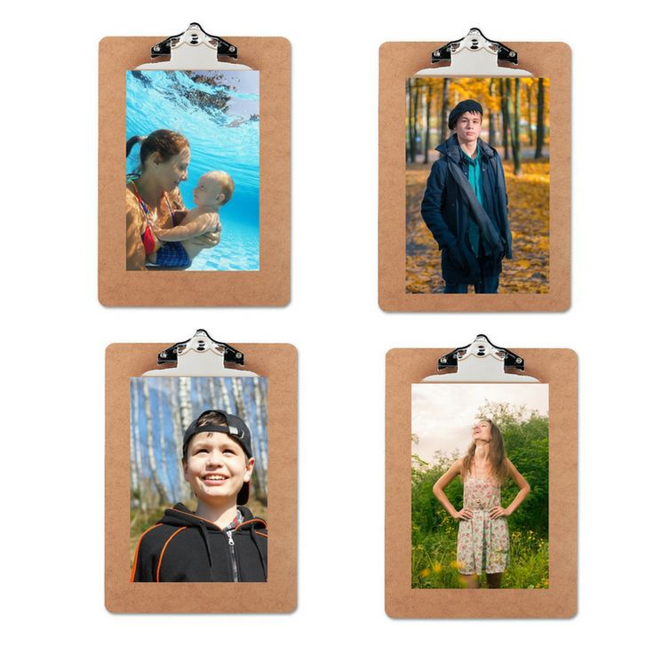 four photos are hanging on a clipboard