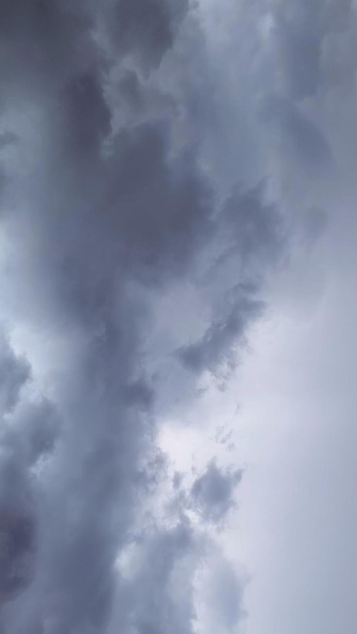 an airplane is flying in the cloudy sky