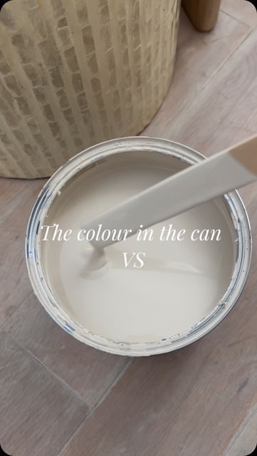 a white paint can being used as a base for a vase with the words, the color in the can vs