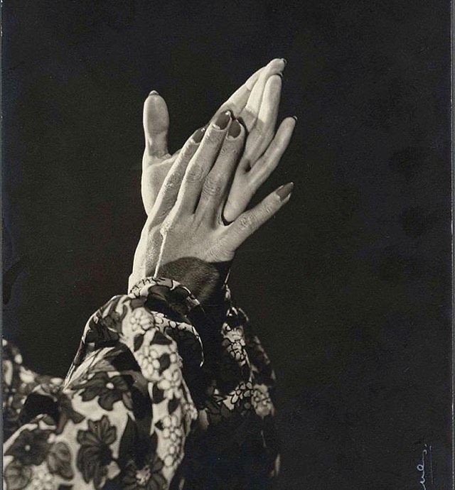 an old black and white photo of a woman's hands