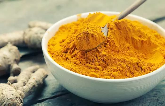 a bowl filled with tumerical and ginger powder