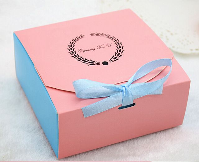 a pink box with a blue ribbon on it