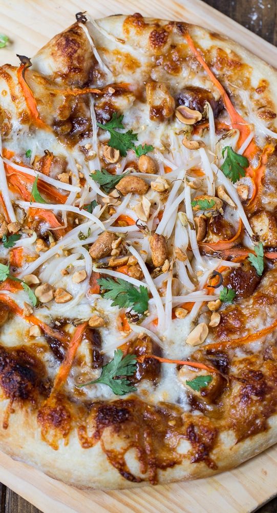 a pizza topped with carrots, parmesan cheese and nuts