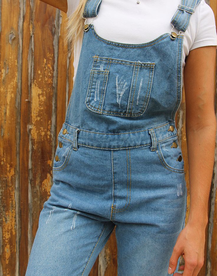 Vintage long dungarees in blue denim. Single front pocket with distressed patches. Front and back pockets. Belt loops. Distressed patches to legs. Size medium, UK 10-12 / EUR 38-40. Measurements - 8.5"(22cm) top of bib - 11"(28cm) bottom of bib - 30"(82cm) waist - 38"(97cm) hips - 29"(74cm) inner leg - 11"(28cm) rise. Material - Denim, 97% Cotton,3% Polyester. Condition - Excellent. Handpicked, repaired and ready to wear. This is an original vintage item, not new and minor signs of wear & age are expected, we will highlight any major flaws. Model is a UK 6/8 and is 5'7" tall. Denim Blue Overalls With Frayed Hem, Denim Overalls With Frayed Hem In Dark Wash, Denim Overalls With Patch Pockets, Blue Denim Washed Shortalls, Blue Washed Denim Shortalls, Light Wash Denim Overalls With Frayed Hem, Denim Shortalls With Pockets In Dark Wash, Dark Wash Denim Shortalls With Pockets, Medium Wash Denim Shortalls With Straight Leg