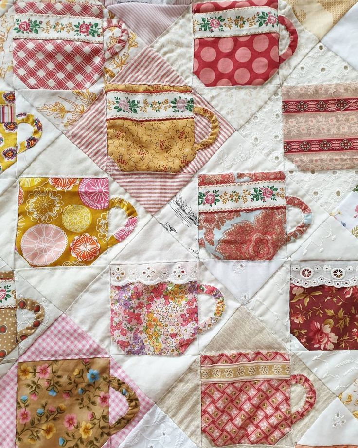 a patchwork quilt with coffee mugs on it