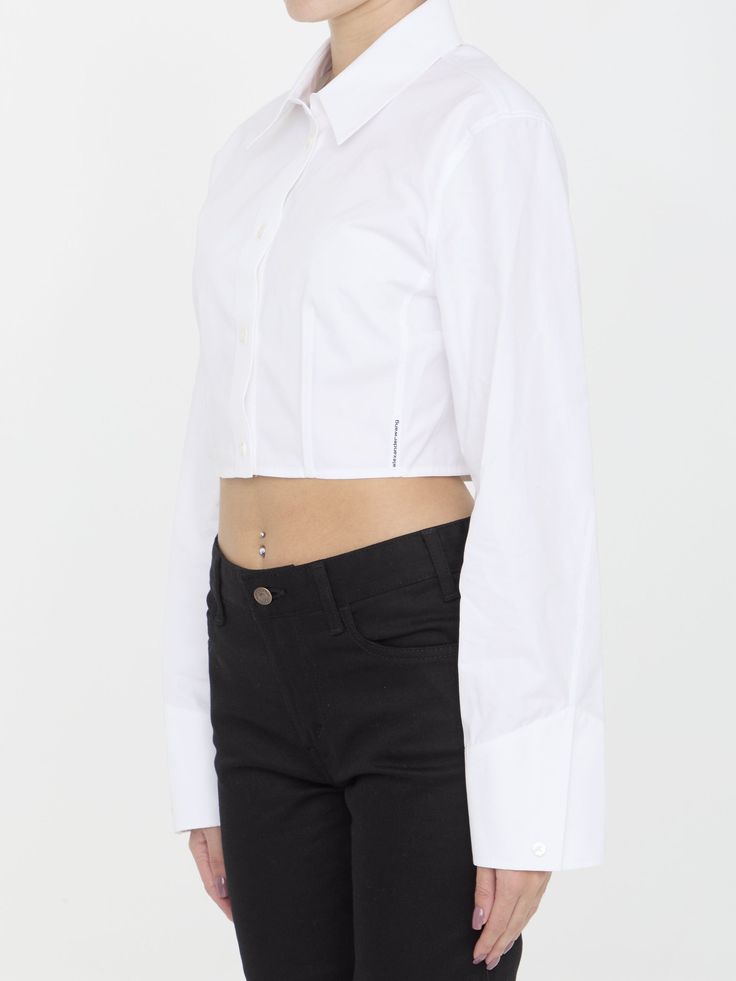 Cropped structured shirt in white organic cotton with boning that runs from the waist to the bust for a sculpting effect. It features classic collar, front button closure and buttoned cuffs. Logo label at the side seam. Fitted cut. The model is 175cm tall and wears size US 6.Size nationality: US Product number: 8316821 Product code: 1WC2241880100 Composition: 100% cotton Elegant Fitted Cotton Cropped Shirt, Chic Fitted Cropped Shirt With Button Cuffs, Chic Fitted Cropped Shirt For Daywear, Classic Cropped Shirt, Fitted Cropped Shirt With Button Cuffs For Work, Classic Cropped Shirt For Daywear, Classic Cropped Shirt With Button Cuffs, Fitted White Cropped Shirt With Buttons, White Long Sleeve Cropped Shirt With Button Closure