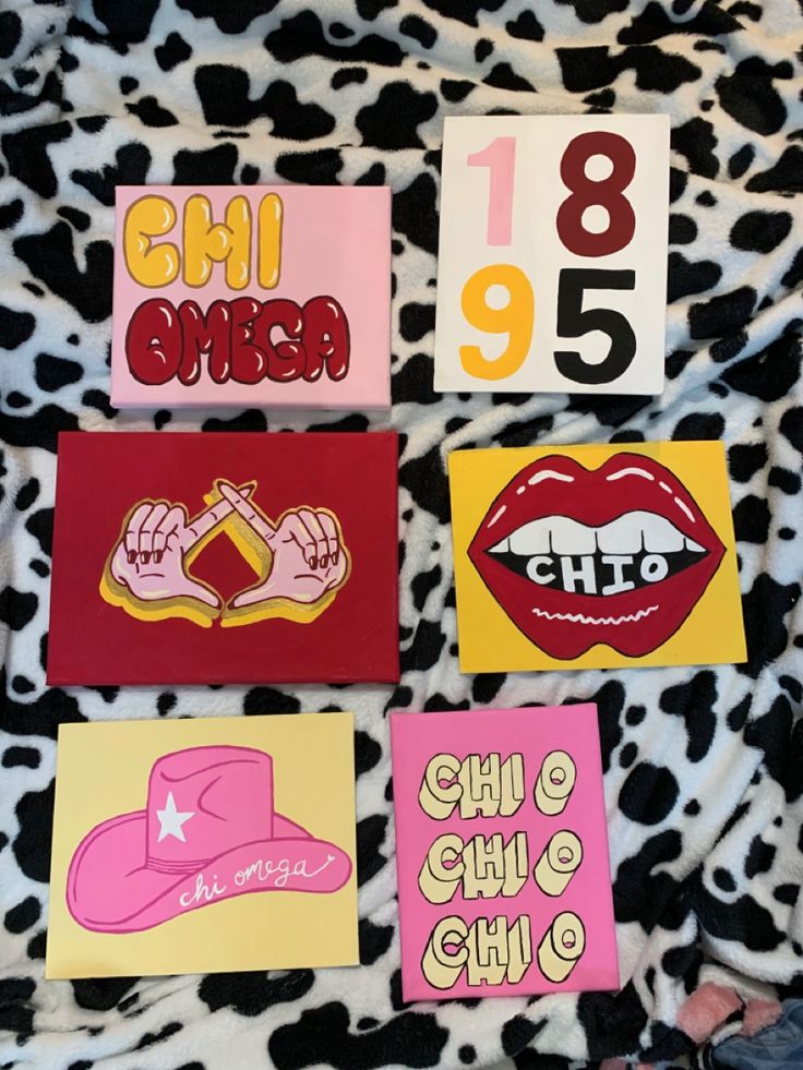 six different colored stickers on top of a cow print blanket with numbers and lips