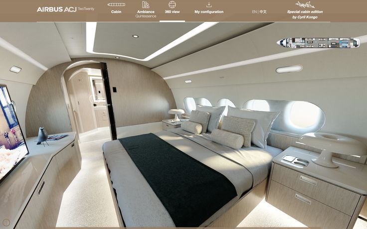 the interior of an airplane with a bed and television in it's center aisle