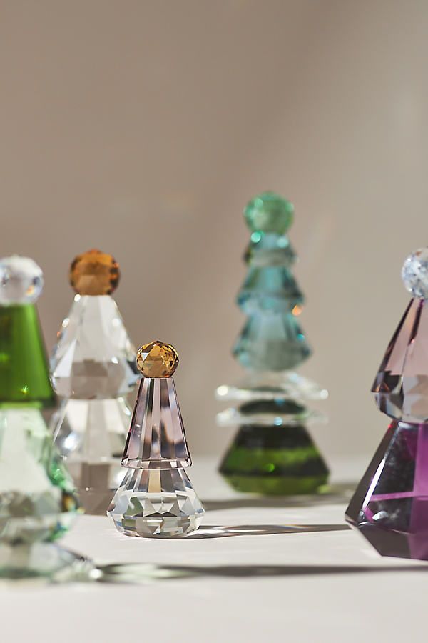 an assortment of colorful glass vases sitting on top of a table