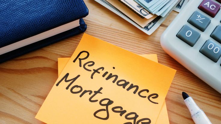 a note with the words refinance mortgage written on it