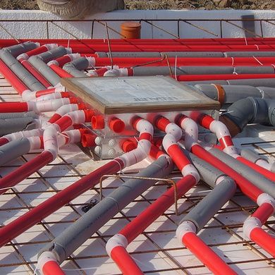 pipes are laid out on the ground to be used for heating and water heaters