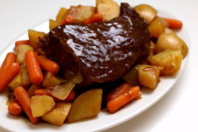 a white plate topped with meat and veggies