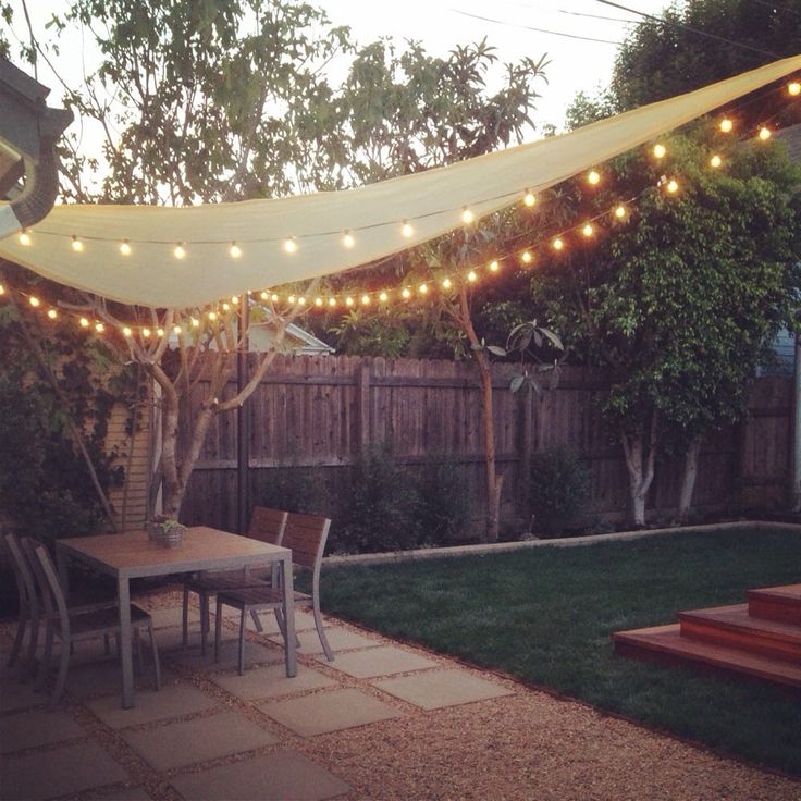 an outdoor patio with string lights strung over it