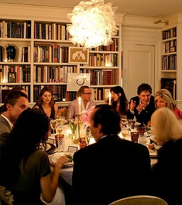 a group of people sitting around a dinner table