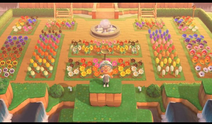 an animal crossing game with lots of flowers and plants on the ground, in front of a fountain