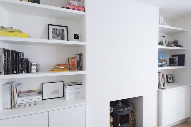 a white book shelf filled with lots of books