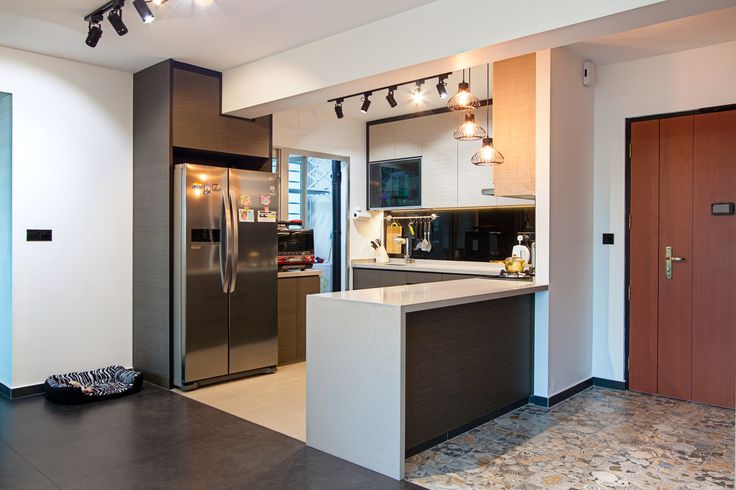 a modern kitchen with stainless steel appliances and marble counter tops, along with an island in the middle