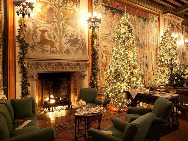 a living room filled with furniture and a fire place covered in christmas tree decorations next to a fireplace