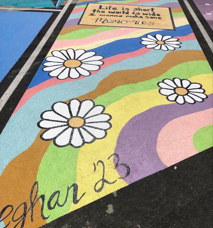 a sidewalk with flowers painted on it and the words john 3 5 written in large letters