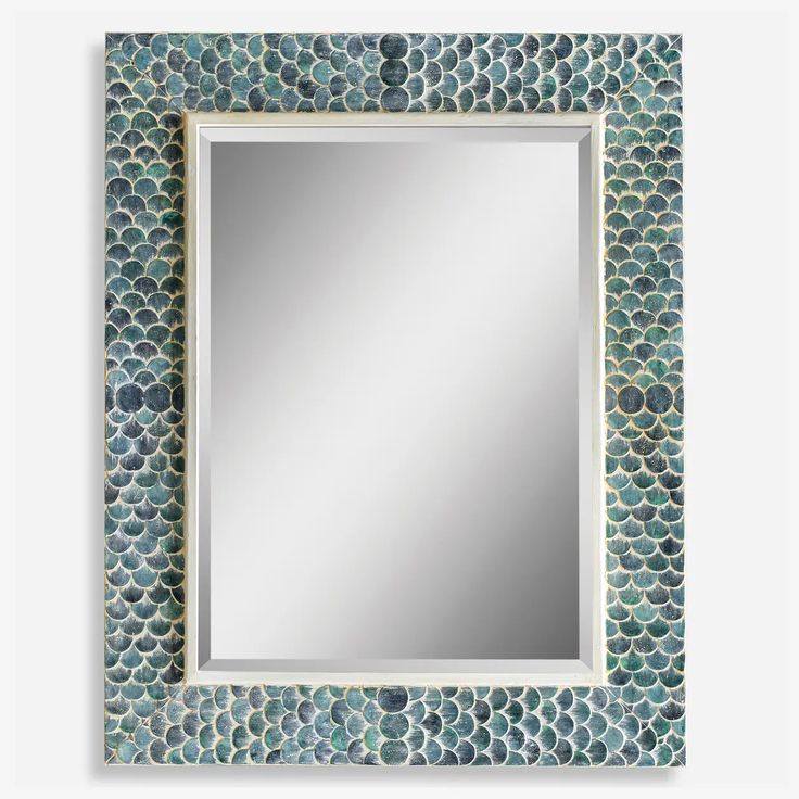 a mirror that is sitting on top of a wall with a fish scale pattern around it