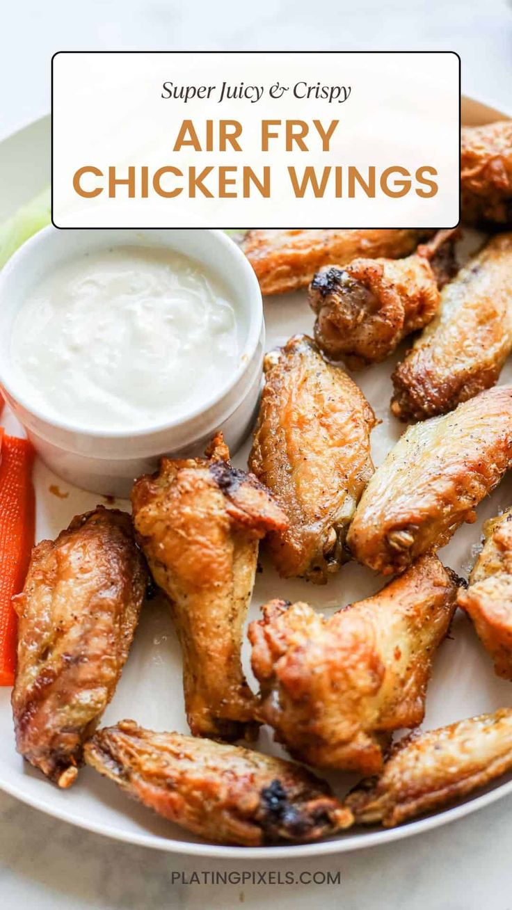 air fry chicken wings on a plate with ranch dip and carrots in the background