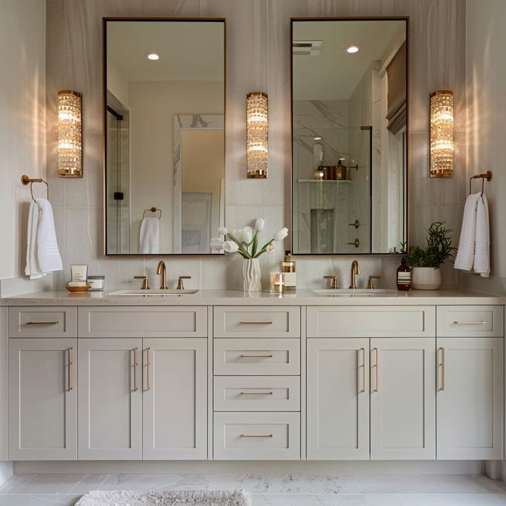 a bathroom with two sinks and mirrors in it