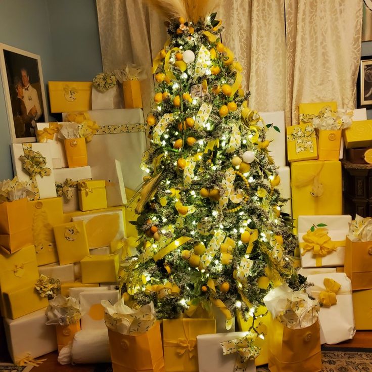 a yellow christmas tree surrounded by presents