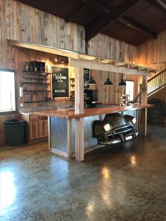 an old car is parked in front of a bar with shelves on the wall behind it