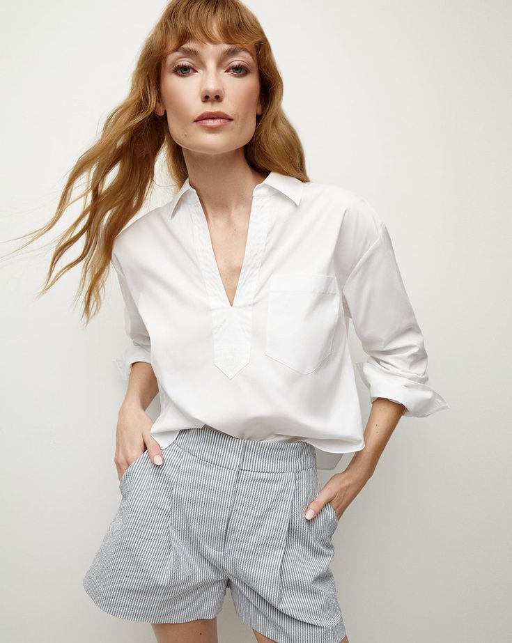 Endlessly versatile, the Khai is the go-to top every woman needs—perfect on its own or as a layering essential. Expertly tailored from premium cotton poplin—with stretch for ease—this billowy, relaxed silhouette is finished with a neat collar, a split V-neck and a single patch pocket. Throw it on over jeans, skirts, shorts—you name it.67% Cotton, 30% Polyamide, 3% SpandexProfessional dry clean onlyStyle #2312LSCP40714 Poplin Top, Patched Jeans, Outerwear Vest, Selling Clothes, Sweaters And Jeans, Veronica Beard, Jeans For Sale, Name It, Cotton Poplin