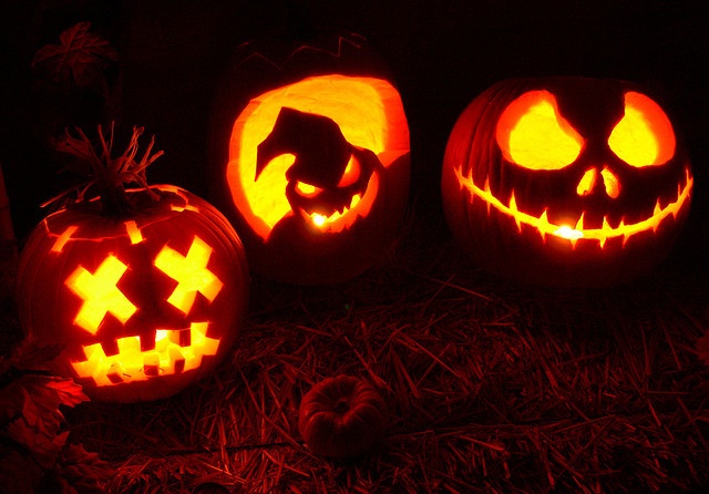 three pumpkins with faces carved into them