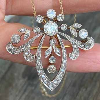 "Details: Edwardian Belle Époque diamond pendant from the early 1900's. There is a count of 50 diamonds, the largest being 5mm close to 1/2 carat. There are 5 large bezel set Old European Cut diamonds and the balance are bead set and bezel set rose cut diamonds. Mille grain work on all edges is meticulously finished. The center five diamonds move independently of the surround. A very pretty piece in excellent condition. The gold pendant tests at 18K and the 16\" modern chain is 14K gold. The pin Classic Diamond White Diamond Brooch, Victorian Diamond Filigree Brooches, Luxury Diamond Brooch With Rose Cut Diamonds, Elegant Diamond Brooches With Accents, Diamond Filigree Brooches As Gift, Antique White Gold Brooches With Rose Cut Diamonds, Antique White Gold Diamond Necklace, Victorian Diamond Necklace With Single Cut Diamonds For Formal, Vintage Yellow Gold Diamond Jewelry