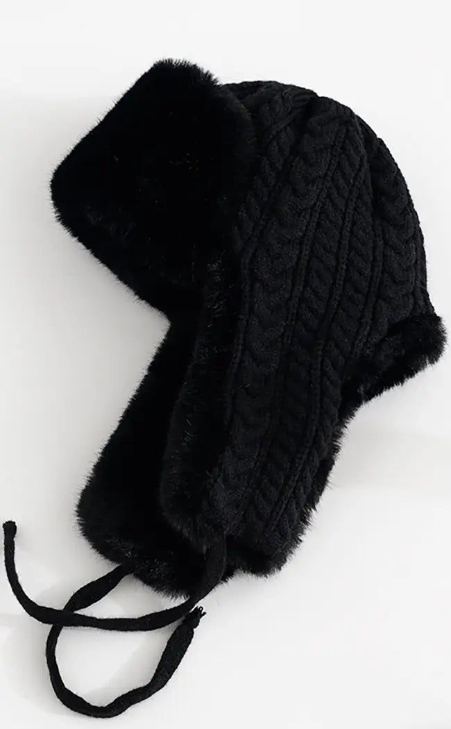 Whether you call these bad boys trapper hats, Russian hats, earflap hats or trooper hats - we know one thing - they warm AF! Keep your head wintergoth cosy in this faux fur woolly hat with extended earflaps on the side and woven black ties. A cable knit pattern on the back gives some granny chic glam and the fur shows on the underside of the sides and along the top brim One size fits most. Windproof Winter Hats With Ear Flaps, Warm Winter Hats With Ear Flaps, Warm Bonnet With Ear Flaps For Cold Weather, Winter Cap With Plush Lining, Winter Beanie With Ear Flaps, Warm Beanie With Ear Flaps For Winter, Winter Outdoor Bonnet With Ear Flaps, Warm Winter Beanie With Ear Flaps, Warm Bonnet With Ear Flaps For Winter